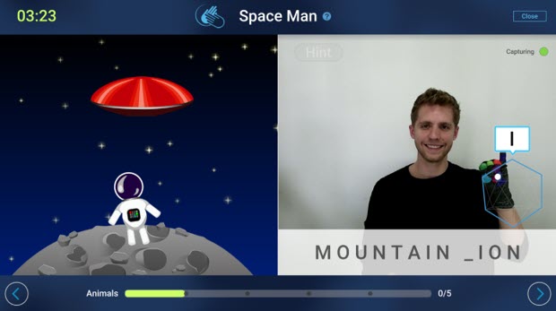 Screenshot of a SignAll user playing the Space Man game and learning to sign the letter "i"