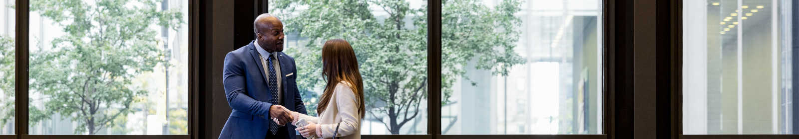 People shaking hands at a bank