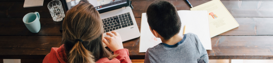 mother and son with disabilities watching video on laptop
