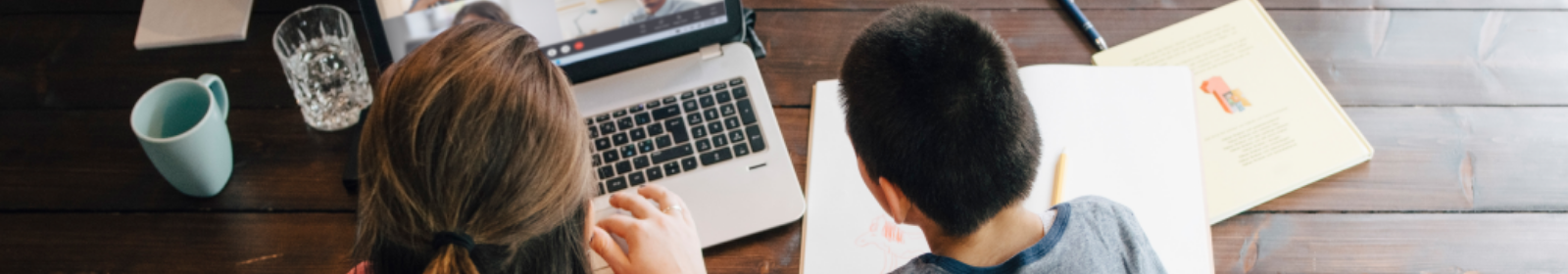mother and son with disabilities watching video on laptop