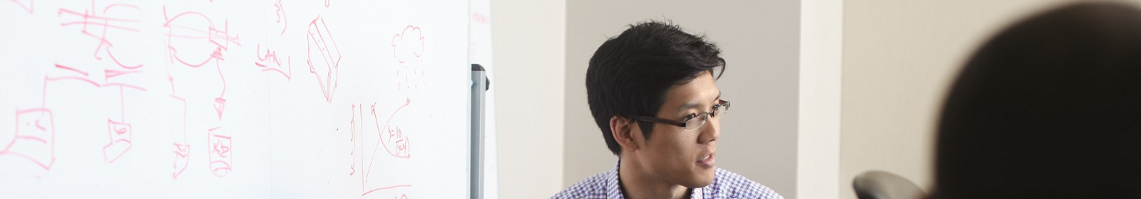 A tech worker leads a whiteboard session