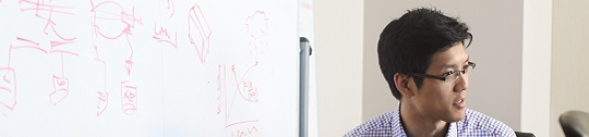 A tech worker leads a whiteboard session