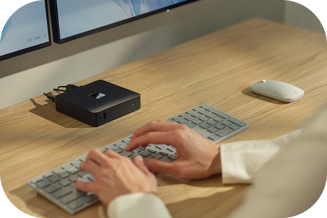 Shot from above of hands typing on a keyboard.