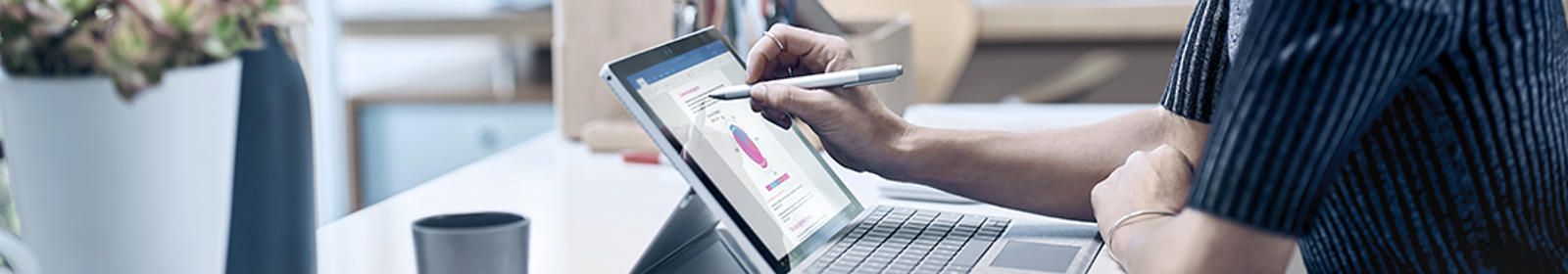 A woman works on a Microsoft Surface device
