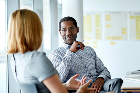 Two colleagues in an office discussing a project