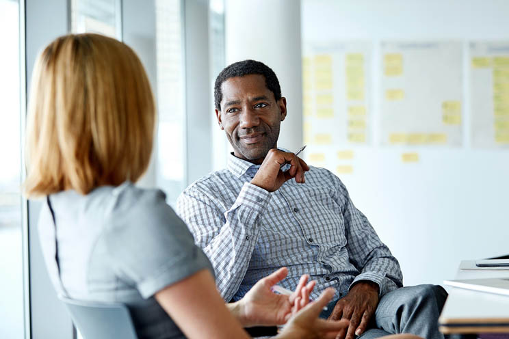 Two colleagues in an office discussing a project