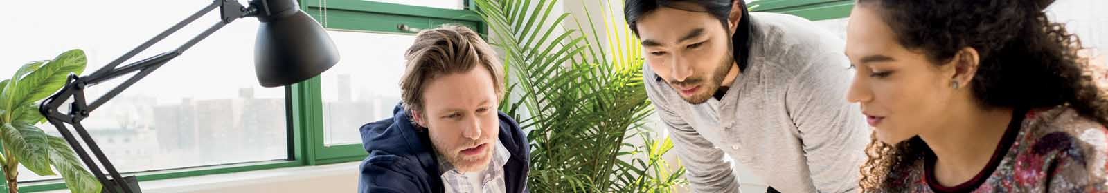 Three colleagues collaborating in an office