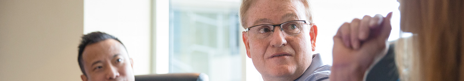 Man listening to coworker in meeting