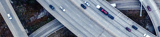 Cars drive on a freeway interchange