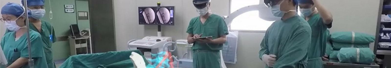 Surgeons work on a patient by using HoloLens
