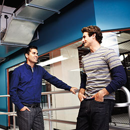 Two men having discussion in factory