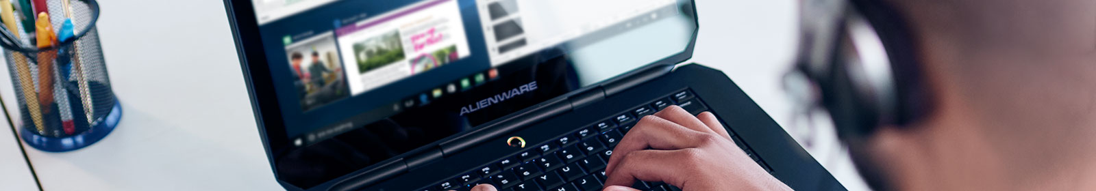 Person wearing headphones working on laptop