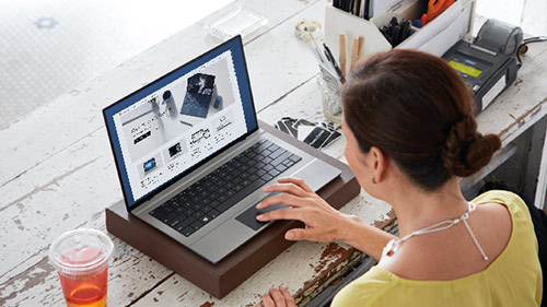 Woman sitting in café working on laptop