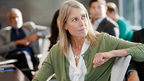 Woman sitting in chair listening to a presentation