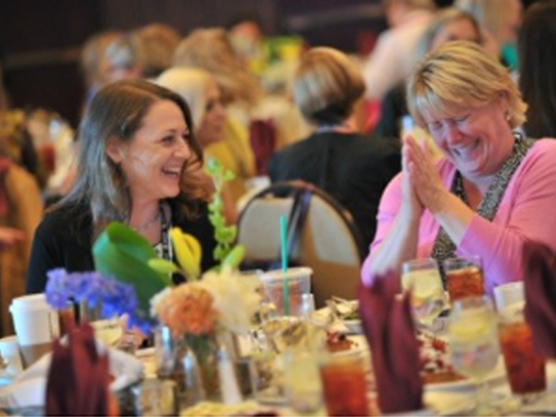 Two women network at the Women In Technology conference