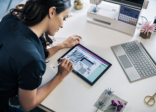 Woman working on tablet at desk