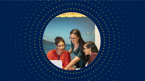 People in an office looking at a computer