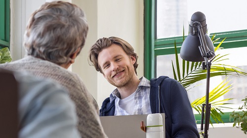 2 people talking and one person smiling