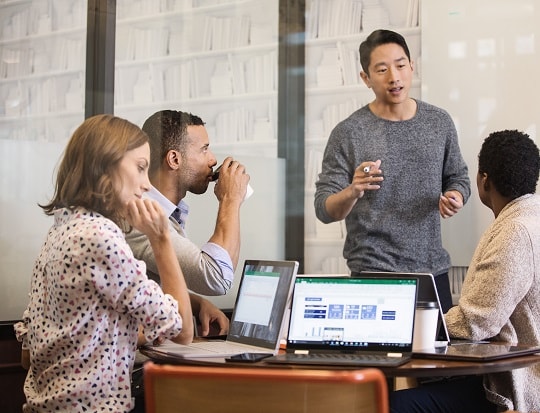 A meeting room with people collaborating