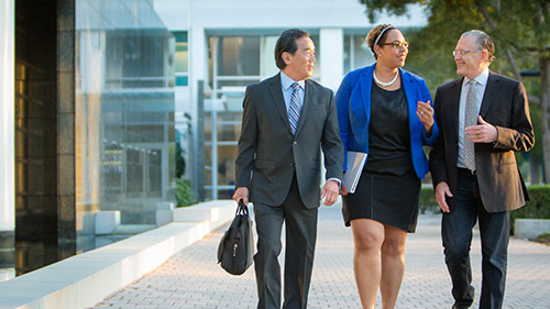three person are walking