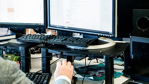 person working on multiple systems