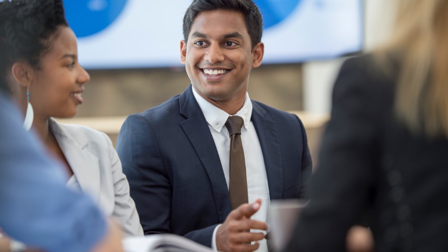 man laughing in meeting room
