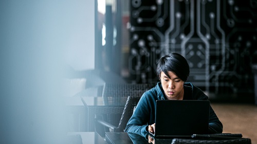 A person sitting in front of a computer