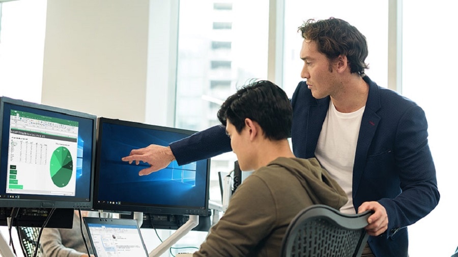 two men working on desktop