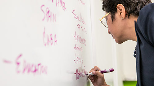 Man writing on board