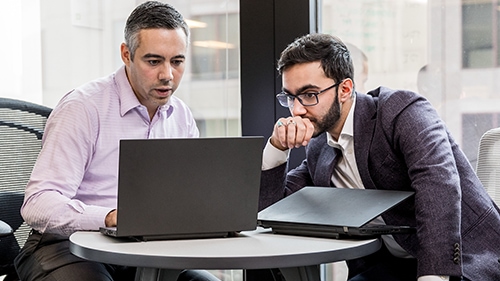 men working on laptop