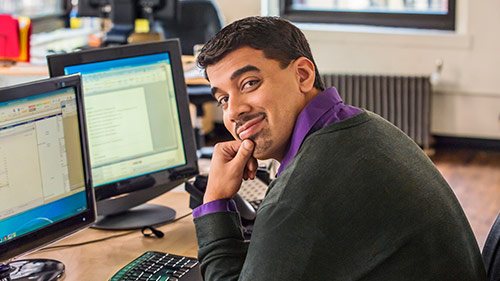 A smiling man with desktop