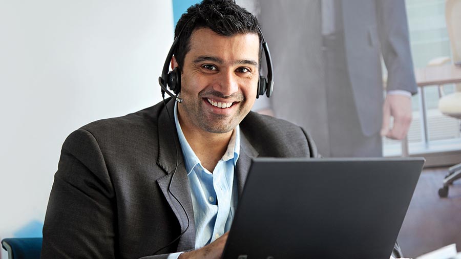 A smiling man with laptop