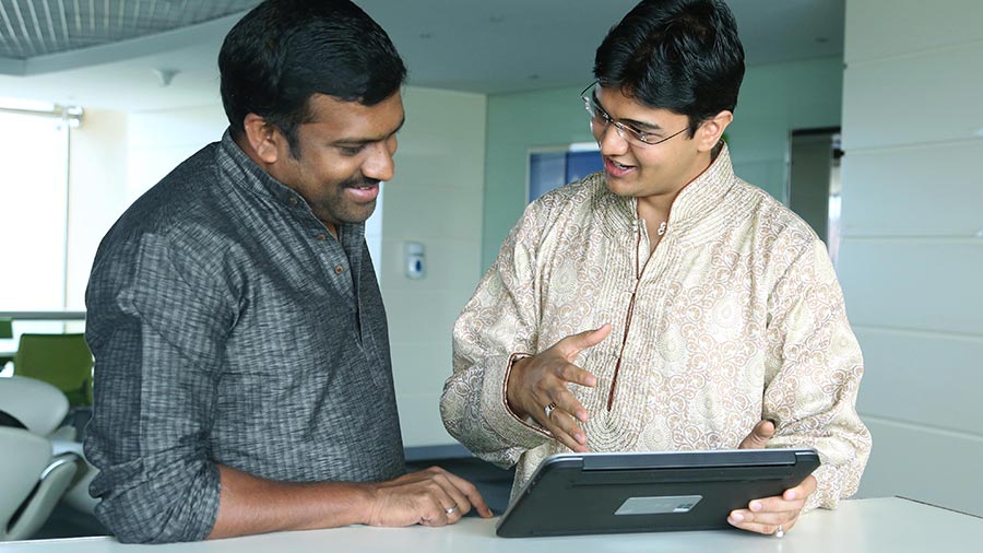 Two men in conversation with tablet