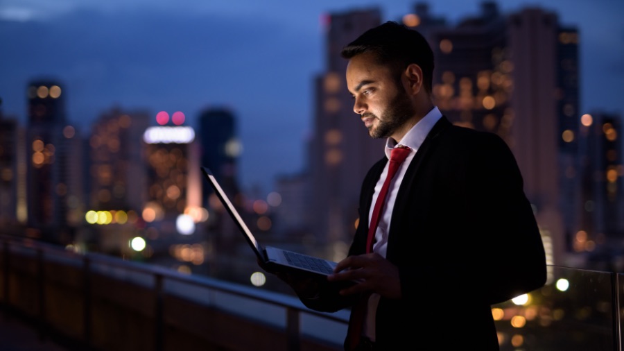 man working on laptop on roof