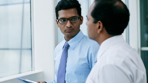 two men discussing in office