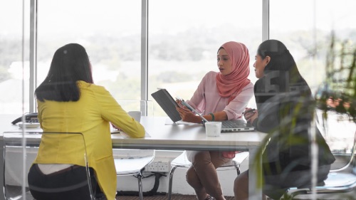 three women working in meeting room