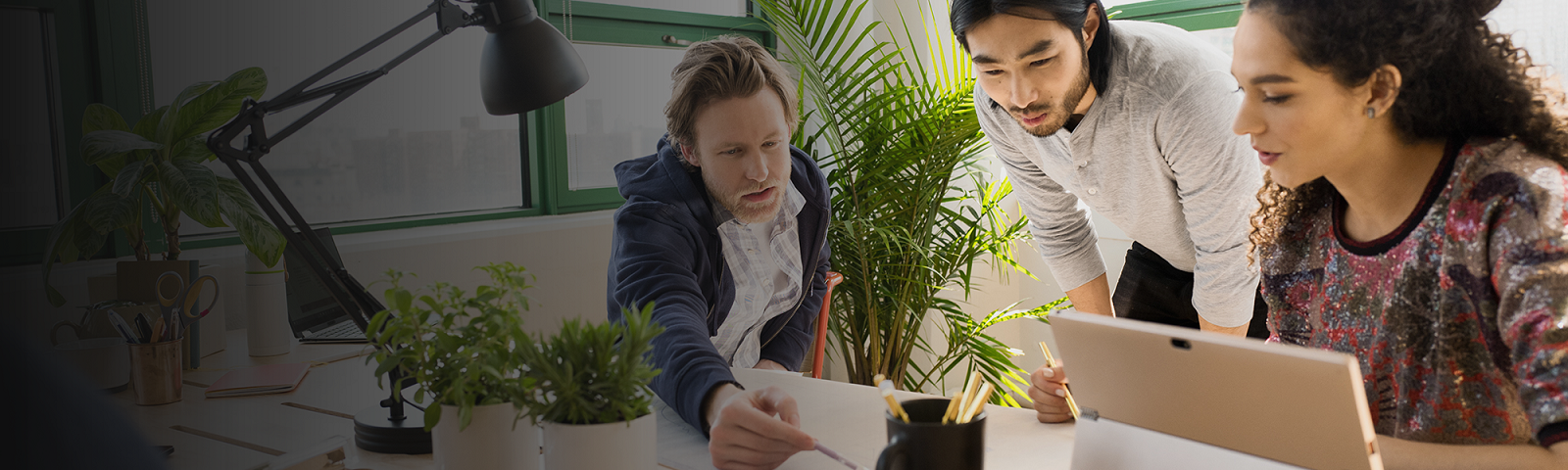 Three people discussing in an office
