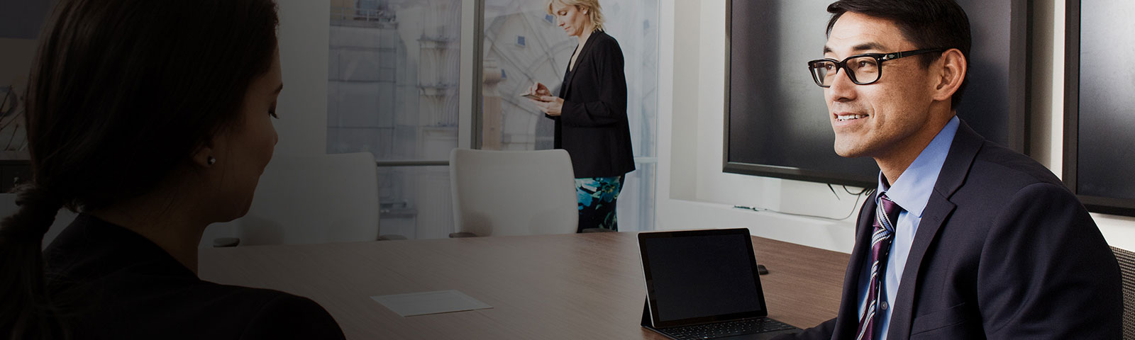Three people in a meeting room