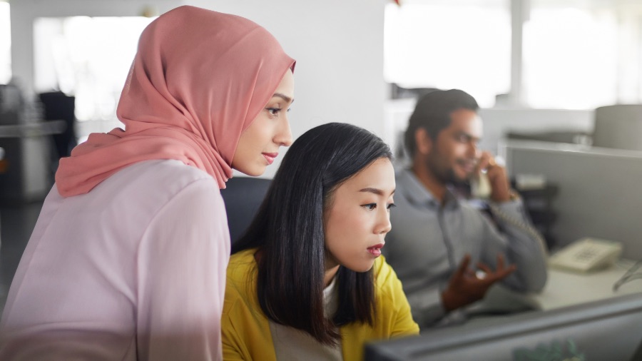 Two girls working on desktop