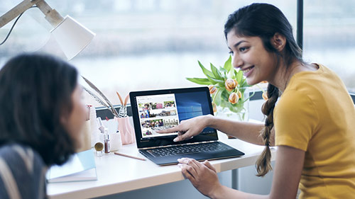 Two women are in conversation with laptop