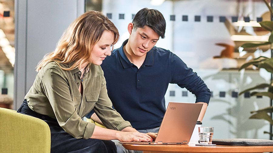 man and woman working on laptop