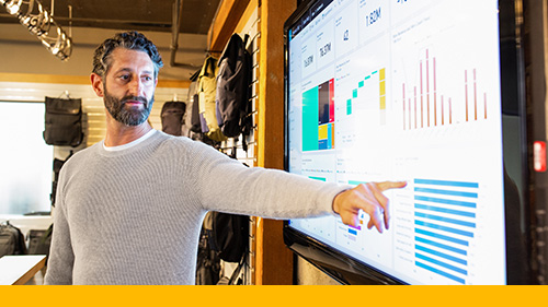 Main pointing to a screen with data 
