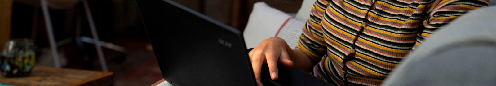 K-12 student at home, using an Acer Spin Travelmate B3 for remote learning