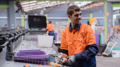 Man smiling sorting recycling