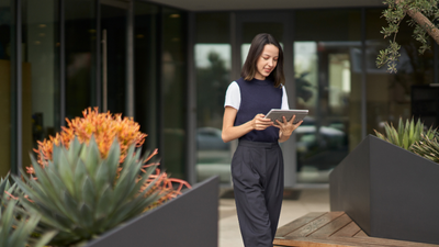 Women working on tablet outside