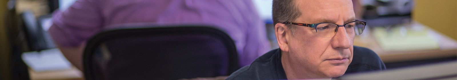 Person sitting at desk facing computer