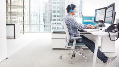 Male with headphones working on computer