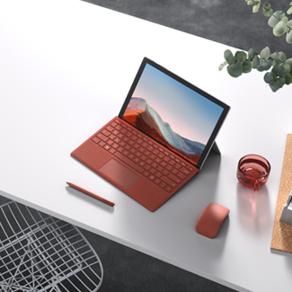 open screen Surface laptop sitting on white table