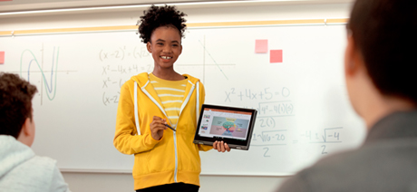 Student presenting on a tablet in a classroom