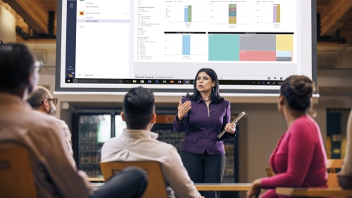 Woman presenting data in classroom.
